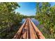 Picturesque view of the boardwalk leading to a waterfront area surrounded by trees at 3409 10Th W Ln, Palmetto, FL 34221