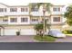 Multi-story condo building with garages and lush landscaping at 3409 10Th W Ln, Palmetto, FL 34221