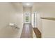 Tiled hallway with granite shelving and neutral walls leading to outside door at 3409 10Th W Ln, Palmetto, FL 34221