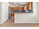 Kitchen featuring wooden cabinetry, stainless steel refrigerator and tiled floor at 3409 10Th W Ln, Palmetto, FL 34221