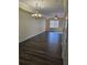 Open-concept living room with hardwood style flooring, ceiling fan, and chandelier at 3409 10Th W Ln, Palmetto, FL 34221