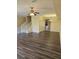 An inviting living room with wood flooring, a ceiling fan, and plenty of natural light and access to the dining area at 3409 10Th W Ln, Palmetto, FL 34221