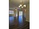 Open-concept living room with hardwood style flooring, ceiling fan, and sliding glass doors at 3409 10Th W Ln, Palmetto, FL 34221