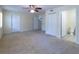 Spacious bedroom with neutral walls, carpet flooring, a ceiling fan, and an ensuite bathroom and closet at 3409 10Th W Ln, Palmetto, FL 34221