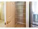 Pantry with shelving unit next to a stainless steel refrigerator at 3409 10Th W Ln, Palmetto, FL 34221