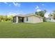 Expansive backyard features a screened lanai, lush lawn, and neutral exterior paint at 3415 68Th Street E Cir, Palmetto, FL 34221