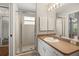 Bathroom with glass-enclosed shower and white vanity with generous counter space at 3415 68Th Street E Cir, Palmetto, FL 34221