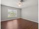 Inviting bedroom with hardwood floors, a ceiling fan, and a sunlit window at 3415 68Th Street E Cir, Palmetto, FL 34221