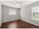 Well-lit bedroom features wood flooring and two windows at 3415 68Th Street E Cir, Palmetto, FL 34221