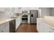 Bright kitchen with stainless steel appliances, white cabinets, and a stylish breakfast bar area at 3415 68Th Street E Cir, Palmetto, FL 34221