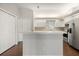 Kitchen with white cabinets, stainless steel appliances, and an open layout leading into the living area at 3415 68Th Street E Cir, Palmetto, FL 34221