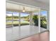 Enclosed lanai with screened windows offering views of a serene pond and lush greenery at 3415 68Th Street E Cir, Palmetto, FL 34221