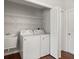 Laundry room features a utility sink, washer, dryer, and wire shelving at 3415 68Th Street E Cir, Palmetto, FL 34221