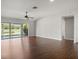 Spacious living room with hardwood floors, ceiling fan, and sliding glass doors that showcase beautiful backyard views at 3415 68Th Street E Cir, Palmetto, FL 34221