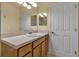 Bathroom vanity features light wood cabinets, a large mirror and a white sink at 3707 45Th W Ter # 104, Bradenton, FL 34210