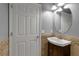 This powder room features a modern vanity, decorative backsplash, and neutral tones at 3707 45Th W Ter # 104, Bradenton, FL 34210
