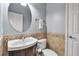 Powder room features a modern vanity with decorative tile backsplash, mirror, and neutral tones at 3707 45Th W Ter # 104, Bradenton, FL 34210