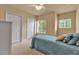 Bright bedroom featuring two closets, two windows and bed with accent pillows at 3707 45Th W Ter # 104, Bradenton, FL 34210