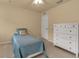Bright bedroom with a twin bed, dresser, and ceiling fan at 3707 45Th W Ter # 104, Bradenton, FL 34210