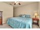 Cozy bedroom featuring a ceiling fan and a comfortable bed with a patterned blue comforter at 3707 45Th W Ter # 104, Bradenton, FL 34210