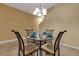 Formal dining room featuring glass table and chairs set with plates and cups at 3707 45Th W Ter # 104, Bradenton, FL 34210