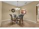 Formal dining room showcases a view into the kitchen and a round mirror at 3707 45Th W Ter # 104, Bradenton, FL 34210