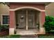 Close-up of the townhouse entrance, featuring unit doors, outdoor lighting and covered entryway at 3707 45Th W Ter # 104, Bradenton, FL 34210