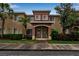 Townhouse exterior featuring well-maintained landscaping, an appealing archway entrance, and a neutral color scheme at 3707 45Th W Ter # 104, Bradenton, FL 34210