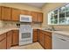Kitchen featuring tile flooring, oak cabinets, window view and modern appliances at 3707 45Th W Ter # 104, Bradenton, FL 34210