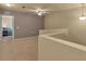 Open landing features carpet, railings, and doorway to bedroom at 3707 45Th W Ter # 104, Bradenton, FL 34210