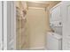 Laundry room with stackable washer and dryer unit and wire shelving at 3707 45Th W Ter # 104, Bradenton, FL 34210