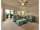 An inviting living room with couches, ottomans, and a large sliding glass door to exterior at 3707 45Th W Ter # 104, Bradenton, FL 34210