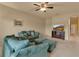 Comfortable living room with plush seating, ceiling fan, and media center offers a relaxing space at 3707 45Th W Ter # 104, Bradenton, FL 34210