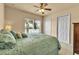 Relaxing main bedroom features a large window with serene water view, ceiling fan, and ample closet space at 3707 45Th W Ter # 104, Bradenton, FL 34210