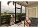 Screened in patio has views of the lake, seating, and a door to the outside at 3707 45Th W Ter # 104, Bradenton, FL 34210