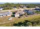 Aerial view featuring a screened-in lanai, a detached shed, and mature palm trees in the backyard at 3835 W Price Blvd, North Port, FL 34286