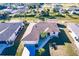 Aerial view of a single-story home featuring a well-kept lawn, a two-car garage, and beautiful landscaping at 3835 W Price Blvd, North Port, FL 34286