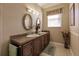 Double vanity bathroom with granite countertops, warm wood cabinets, and decorative floral accents at 3835 W Price Blvd, North Port, FL 34286