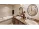Bathroom featuring double sinks, a bathtub with tile surround, and neutral decor at 3835 W Price Blvd, North Port, FL 34286