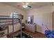 A bedroom with a bunk bed, white walls, hardwood floors and a sunny window at 3835 W Price Blvd, North Port, FL 34286