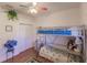 A bedroom featuring a bunk bed, hardwood floors, white walls and a walk-in closet at 3835 W Price Blvd, North Port, FL 34286