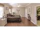 This bedroom features a wooden floor, a ceiling fan and a comfortable bed at 3835 W Price Blvd, North Port, FL 34286