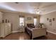 Comfortable bedroom featuring a ceiling fan, natural light, and traditional furnishings at 3835 W Price Blvd, North Port, FL 34286