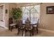 Cozy breakfast nook features a wooden table, four chairs, and a large window with natural light at 3835 W Price Blvd, North Port, FL 34286