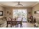 Bright dining room with ceiling fan, sliding glass doors to the patio, and seating for six at 3835 W Price Blvd, North Port, FL 34286