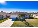 Charming single-story home with a well-manicured lawn, palm trees, and a two-car garage at 3835 W Price Blvd, North Port, FL 34286