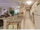Open kitchen with granite countertops, light wood cabinetry, and modern appliances with breakfast bar at 3835 W Price Blvd, North Port, FL 34286