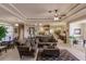 Open-concept living area showcasing a tray ceiling, tile flooring and seamless flow to the kitchen at 3835 W Price Blvd, North Port, FL 34286