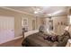 Comfortable main bedroom featuring hardwood floors, a ceiling fan, natural light, and neutral paint at 3835 W Price Blvd, North Port, FL 34286