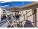 Covered patio featuring an outdoor dining set with seating for four and decorative tropical themed wall decor at 3835 W Price Blvd, North Port, FL 34286
